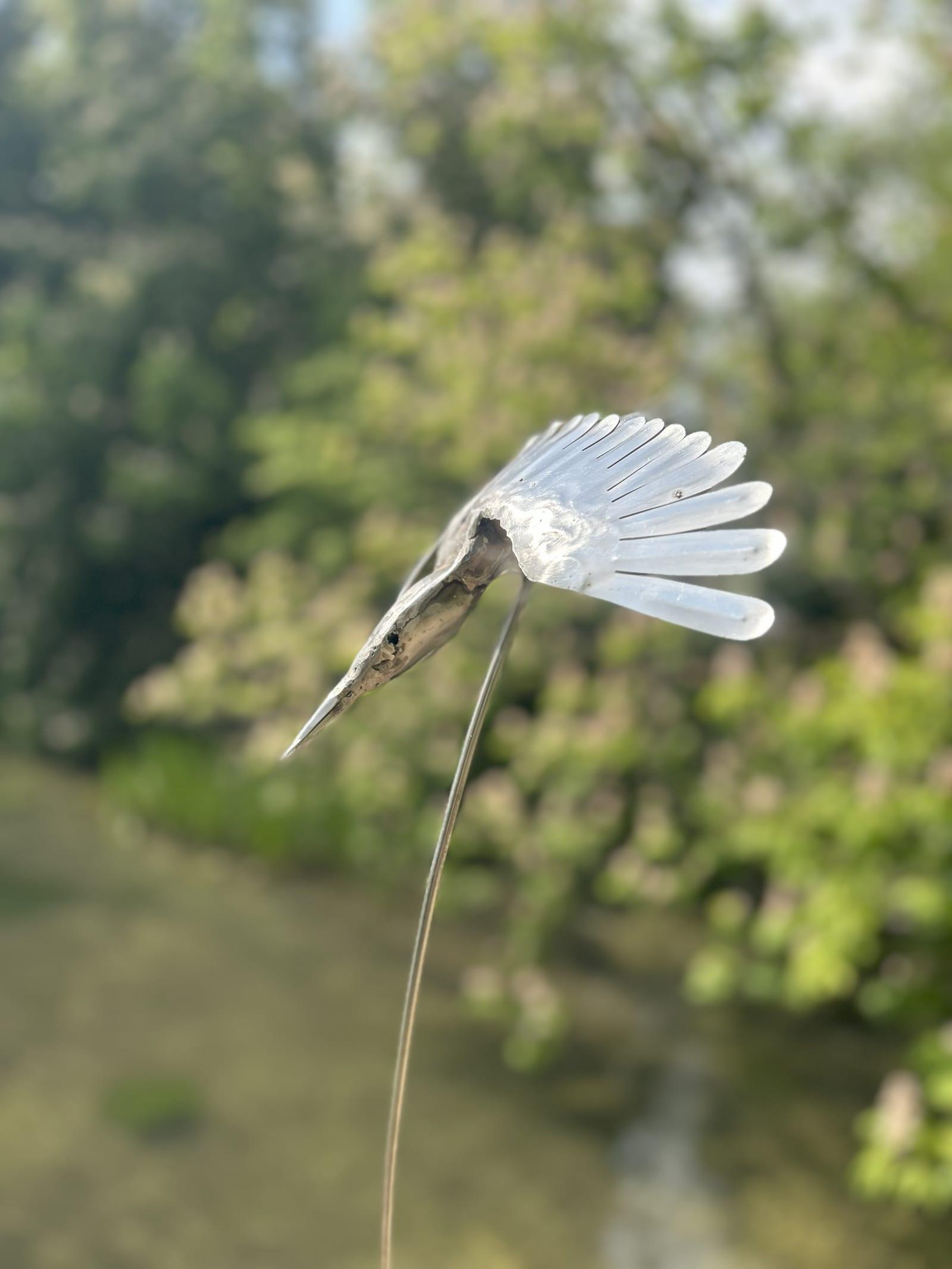 Kingfisher metal sculpture diving, wings spread