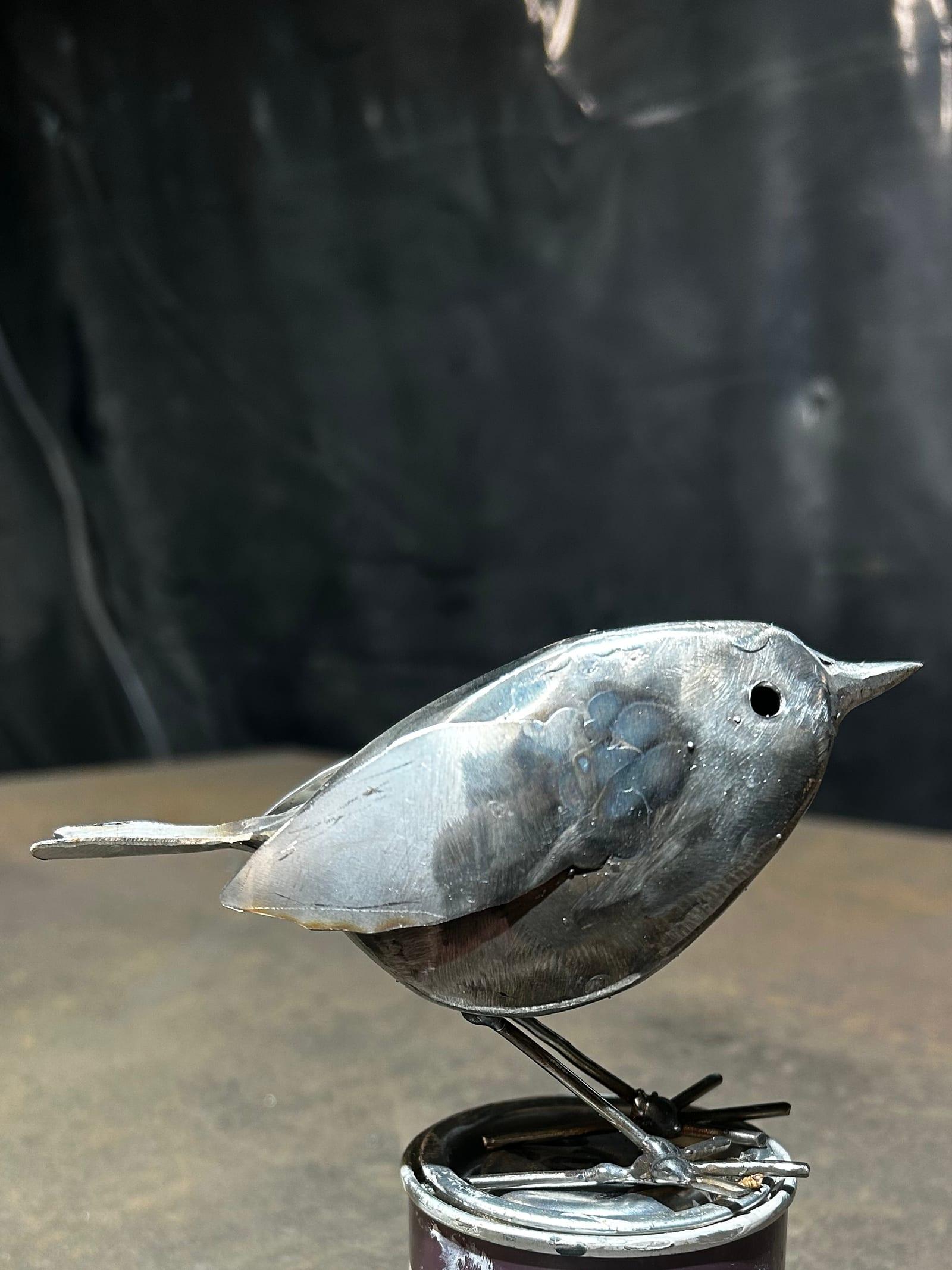 Robin metal sculpture in bright polished stainless steel